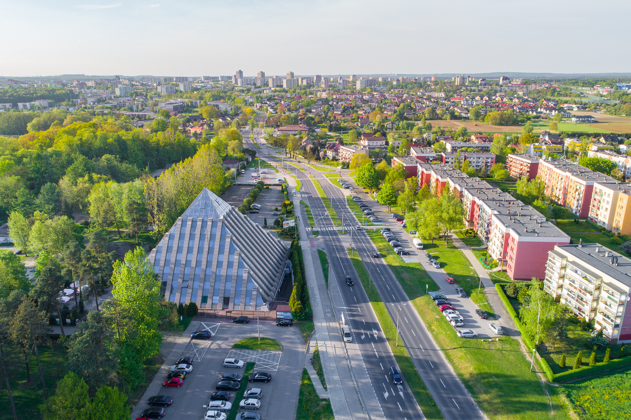 Panorama Tychów z nowoczesną drogą, zielenią miejską i blokami mieszkalnymi. Regały Magazynowe w Tychy